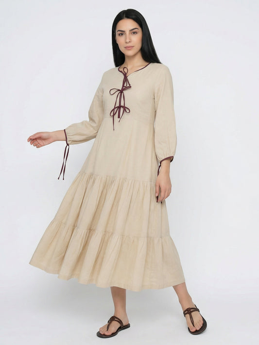 Seen Unseen natural beige linen-blend tiered maxi dress with tie neckline and burgundy trim. Long sleeves with tie cuffs.