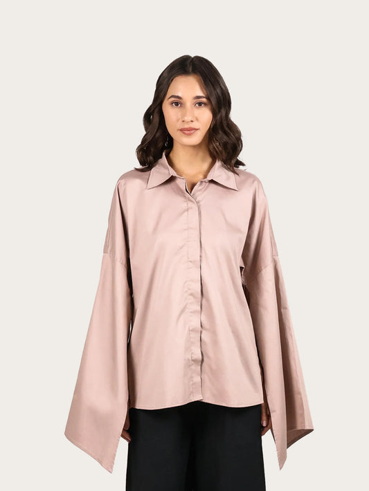 Woman wearing a light pink blouse and black pants on a white background